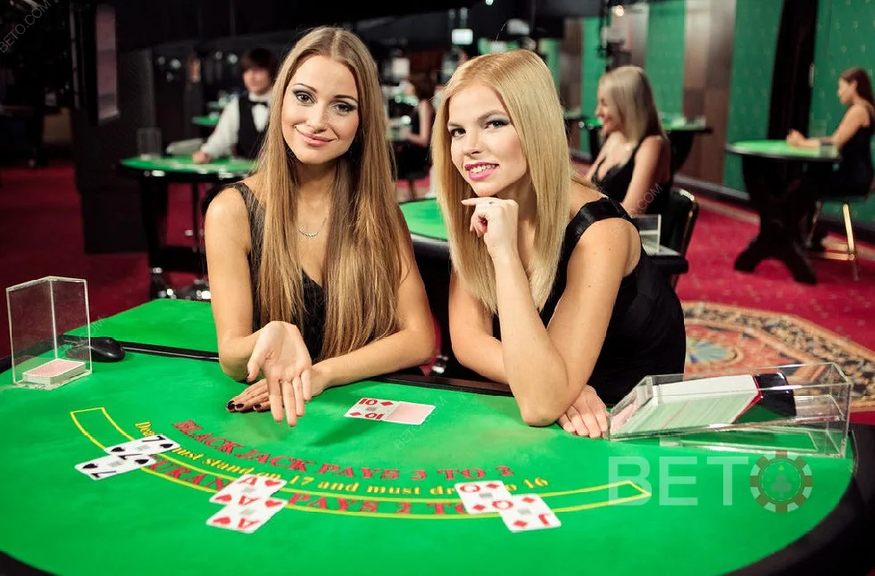 Ruang kasino live dengan meja permainan dan tampilan dealer